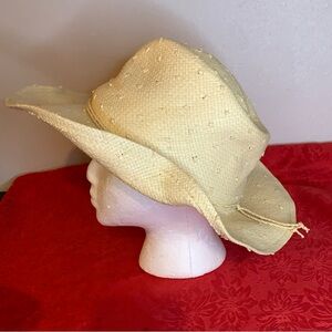 This is a natural -colores Straw cowboy Hat with a braided cord -band